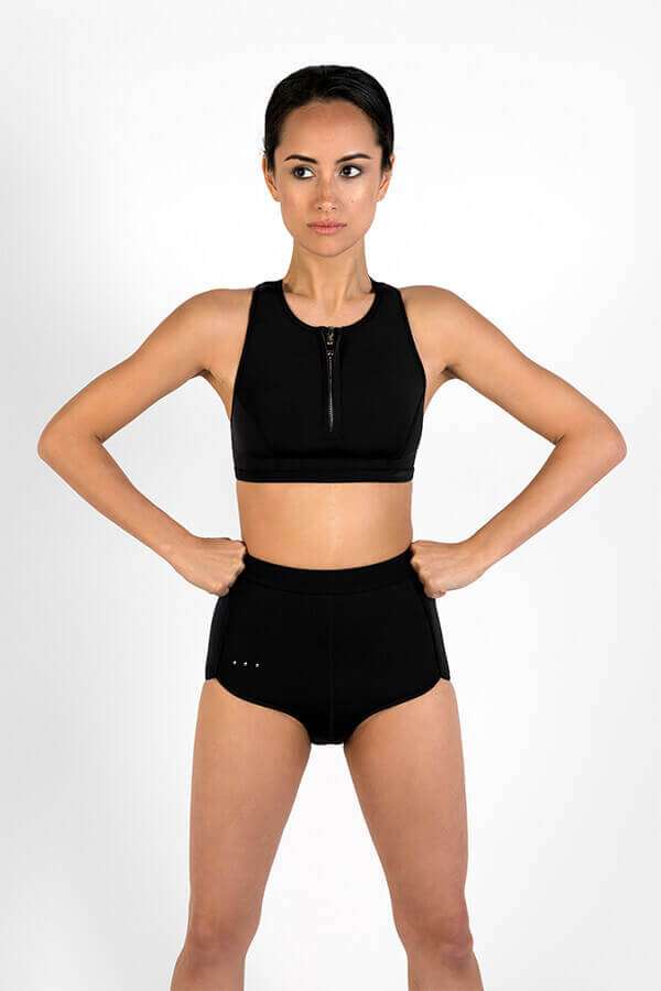 Scoop zip front sports crop bikini top made with Yulex + High waisted sustainable surf shorts - front view in studio